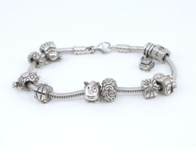 Armband Pandora S925 42,9g Längd 19cm med 8 berlocker och 2 stopp med lite 14K guld på