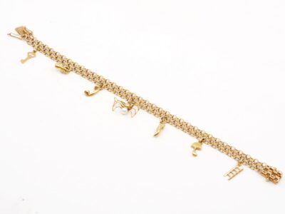 Armband X-länk med sju berlocker 18K Längd 19cm
