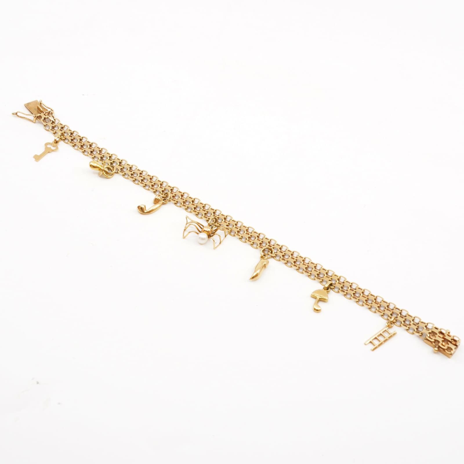 Armband X-länk med sju berlocker 18K Längd 19cm